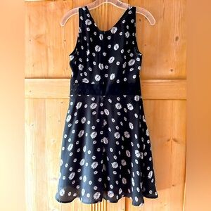 Adorable daisy print black dress with lace detail at waist. Size 2